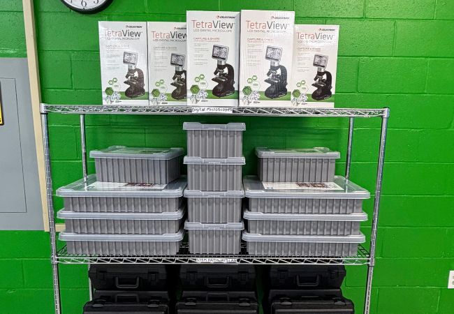 Digital microscopes and lab kits on a rolling shelf